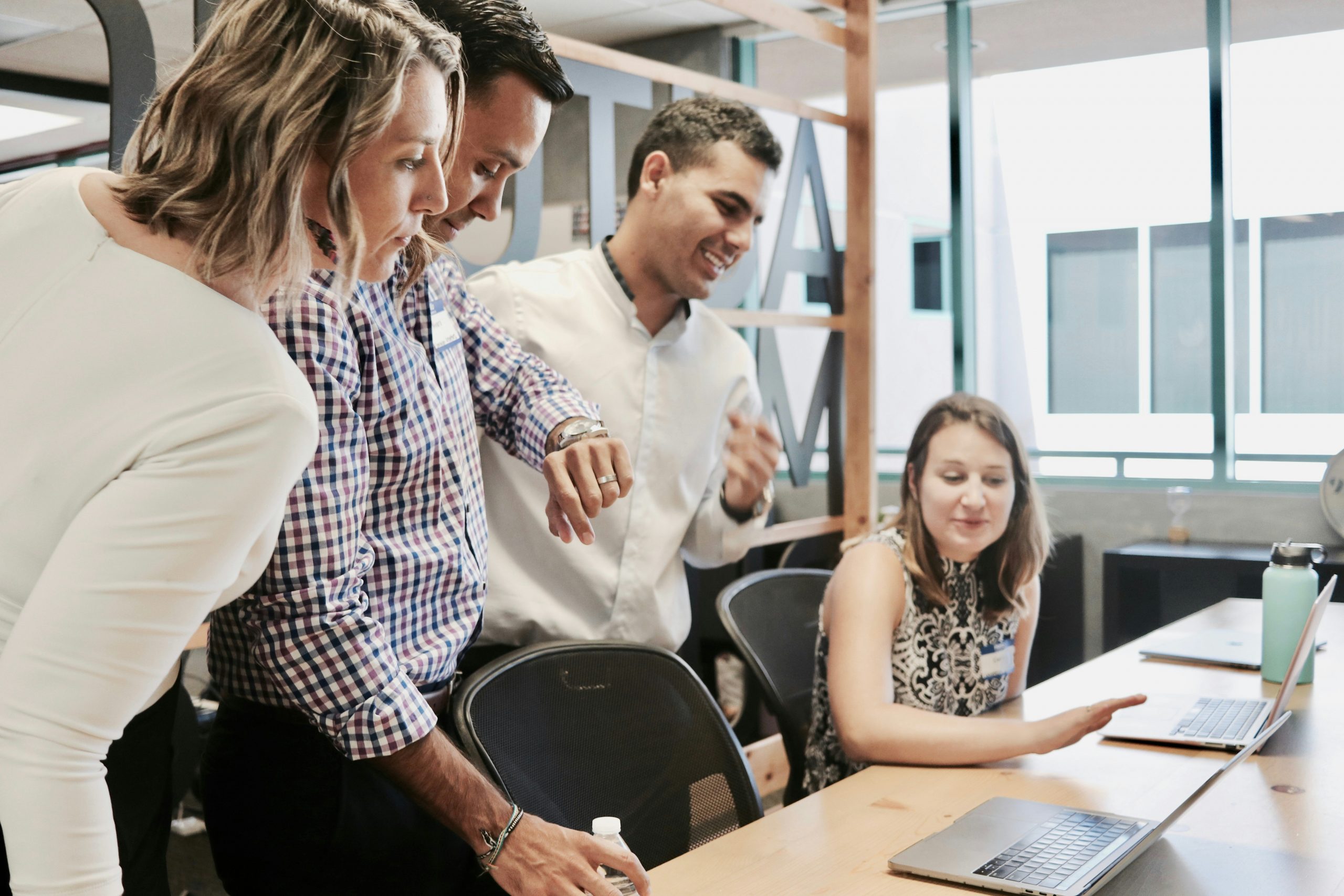 employees talking in an office providing legal support